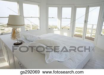 Stock Photograph - windows surrounding 
bedroom. fotosearch 
- search stock 
photos, pictures, 
images, and photo 
clipart
