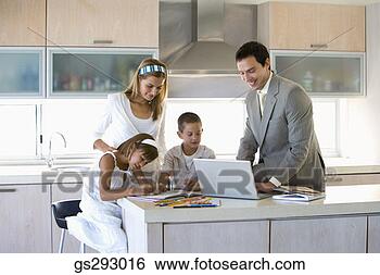 Stock Photo - family using laptop 
in kitchen. fotosearch 
- search stock 
photos, pictures, 
images, and photo 
clipart