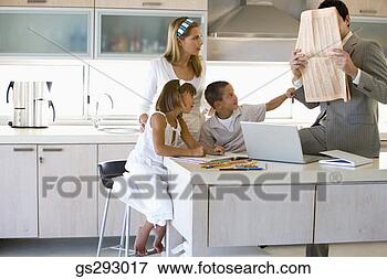 Picture - father reading 
newspaper with 
family in kitchen. 
fotosearch - search 
stock photos, 
pictures, images, 
and photo clipart