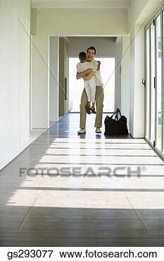 Picture - father and son 
embracing in hallway. 
fotosearch - search 
stock photos, 
pictures, images, 
and photo clipart