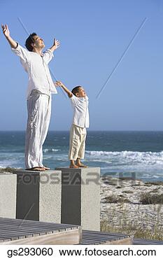 Stock Photography - father and son 
with open arms 
on seashore. fotosearch 
- search stock 
photos, pictures, 
images, and photo 
clipart