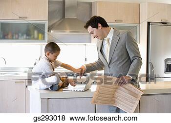 Stock Photo - father and son 
using laptop in 
kitchen. fotosearch 
- search stock 
photos, pictures, 
images, and photo 
clipart