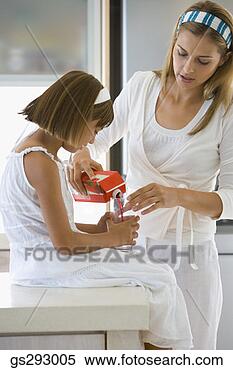 Stock Image - mother pouring 
drink for daughter. 
fotosearch - search 
stock photos, 
pictures, images, 
and photo clipart