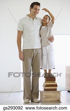 Stock Photo - son standing next 
to father on stack 
of books. fotosearch 
- search stock 
photos, pictures, 
images, and photo 
clipart