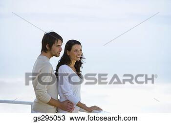 Stock Photo - couple standing 
against railing. 
fotosearch - search 
stock photos, 
pictures, images, 
and photo clipart