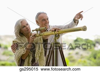 Stock Image - couple with telescope. 
fotosearch - search 
stock photos, 
pictures, images, 
and photo clipart