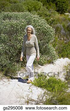 Stock Photo - woman walking 
outdoors. fotosearch 
- search stock 
photos, pictures, 
images, and photo 
clipart