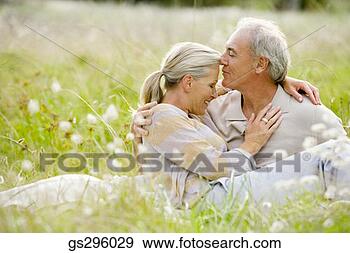 Stock Photograph - affectionate couple 
in field. fotosearch 
- search stock 
photos, pictures, 
images, and photo 
clipart