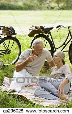 Stock Image - couple on blanket 
in field. fotosearch 
- search stock 
photos, pictures, 
images, and photo 
clipart
