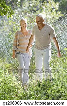 Stock Photo - couple holding 
hands in field. 
fotosearch - search 
stock photos, 
pictures, images, 
and photo clipart