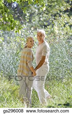 Stock Photo - couple holding 
hands in field. 
fotosearch - search 
stock photos, 
pictures, images, 
and photo clipart