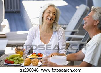 Stock Photo - couple laughing 
by plates of fruit. 
fotosearch - search 
stock photos, 
pictures, images, 
and photo clipart