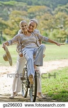 Stock Photo - couple riding 
bike on rural 
path. fotosearch 
- search stock 
photos, pictures, 
images, and photo 
clipart