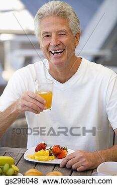 Stock Photo - man with drink 
and fruit. fotosearch 
- search stock 
photos, pictures, 
images, and photo 
clipart