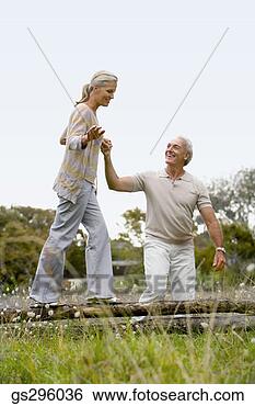 Stock Photo - man helping woman 
balance. fotosearch 
- search stock 
photos, pictures, 
images, and photo 
clipart