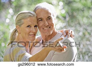 Stock Photo - pointing woman 
hugging man. fotosearch 
- search stock 
photos, pictures, 
images, and photo 
clipart