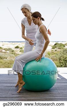 Stock Photograph - teacher helping 
woman on exercise 
ball. fotosearch 
- search stock 
photos, pictures, 
images, and photo 
clipart
