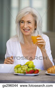 Stock Photo - woman with drink 
and fruit. fotosearch 
- search stock 
photos, pictures, 
images, and photo 
clipart