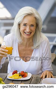 Picture - woman with drink 
and fruit. fotosearch 
- search stock 
photos, pictures, 
images, and photo 
clipart