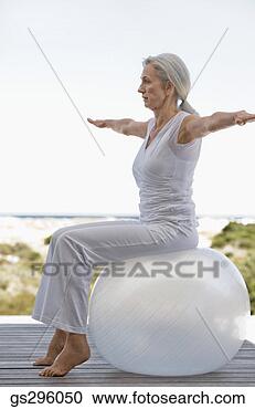 Stock Photography - woman on exercise 
ball. fotosearch 
- search stock 
photos, pictures, 
images, and photo 
clipart