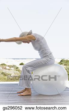Stock Photo - woman on exercise 
ball. fotosearch 
- search stock 
photos, pictures, 
images, and photo 
clipart
