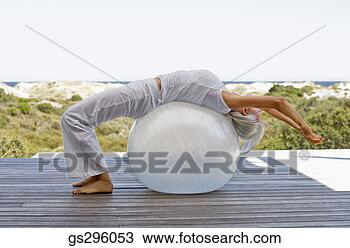 Stock Photo - woman on exercise 
ball. fotosearch 
- search stock 
photos, pictures, 
images, and photo 
clipart