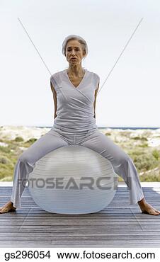 Stock Photo - woman on exercise 
ball. fotosearch 
- search stock 
photos, pictures, 
images, and photo 
clipart
