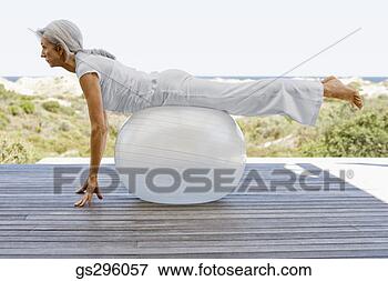 Picture - woman on exercise 
ball. fotosearch 
- search stock 
photos, pictures, 
images, and photo 
clipart