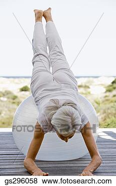 Stock Photo - woman on exercise 
ball. fotosearch 
- search stock 
photos, pictures, 
images, and photo 
clipart