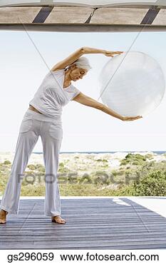 Stock Photograph - woman on exercise 
ball. fotosearch 
- search stock 
photos, pictures, 
images, and photo 
clipart