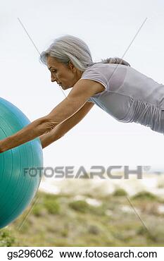 Stock Photo - woman on exercise 
ball. fotosearch 
- search stock 
photos, pictures, 
images, and photo 
clipart