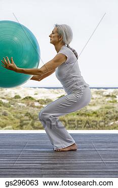 Stock Photo - woman on exercise 
ball. fotosearch 
- search stock 
photos, pictures, 
images, and photo 
clipart
