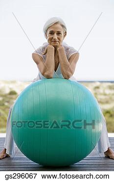 Picture - woman on exercise 
ball. fotosearch 
- search stock 
photos, pictures, 
images, and photo 
clipart