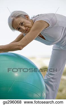 Stock Photo - woman on exercise 
ball. fotosearch 
- search stock 
photos, pictures, 
images, and photo 
clipart