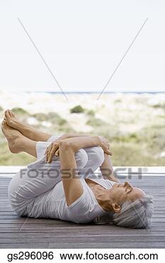 Stock Photo - woman stretching 
by beach. fotosearch 
- search stock 
photos, pictures, 
images, and photo 
clipart