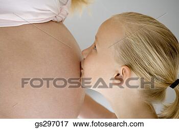 Picture - girl kissing pregnant 
mother's stomach. 
fotosearch - search 
stock photos, 
pictures, images, 
and photo clipart