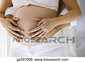 Stock Photograph - man feeling pregnant 
woman's belly. 
fotosearch - search 
stock photos, 
pictures, images, 
and photo clipart