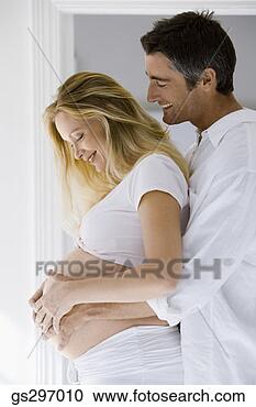 Stock Photography - man feeling pregnant 
woman's belly. 
fotosearch - search 
stock photos, 
pictures, images, 
and photo clipart