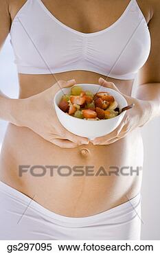 Stock Image - pregnant woman 
with bowl of fruit. 
fotosearch - search 
stock photos, 
pictures, images, 
and photo clipart