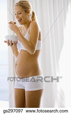 Picture - pregnant woman 
eating fruit. 
fotosearch - search 
stock photos, 
pictures, images, 
and photo clipart