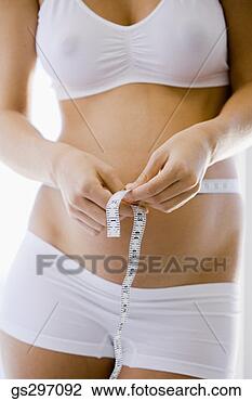 Stock Photo - pregnant woman 
with measuring 
tape. fotosearch 
- search stock 
photos, pictures, 
images, and photo 
clipart