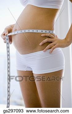 Stock Photo - pregnant woman 
measuring stomach. 
fotosearch - search 
stock photos, 
pictures, images, 
and photo clipart