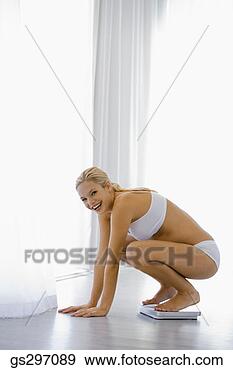 Stock Photograph - pregnant woman 
on scale. fotosearch 
- search stock 
photos, pictures, 
images, and photo 
clipart