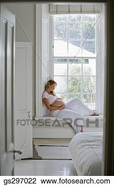 Stock Photo - pregnant woman 
sitting by window. 
fotosearch - search 
stock photos, 
pictures, images, 
and photo clipart