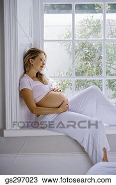 Stock Photo - pregnant woman 
sitting by window. 
fotosearch - search 
stock photos, 
pictures, images, 
and photo clipart