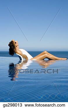 Stock Photo - woman relaxing 
in infinity pool. 
fotosearch - search 
stock photos, 
pictures, images, 
and photo clipart