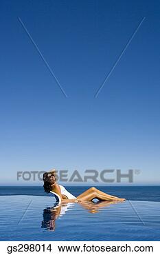 Stock Photo - woman relaxing 
in infinity pool. 
fotosearch - search 
stock photos, 
pictures, images, 
and photo clipart