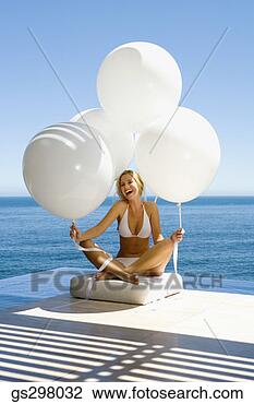 Stock Photo - woman sitting 
seaside with balloons. 
fotosearch - search 
stock photos, 
pictures, images, 
and photo clipart