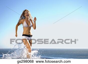 Stock Photo - woman splashing 
in sea. fotosearch 
- search stock 
photos, pictures, 
images, and photo 
clipart