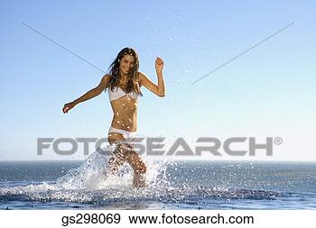 Stock Photograph - woman splashing 
in sea. fotosearch 
- search stock 
photos, pictures, 
images, and photo 
clipart